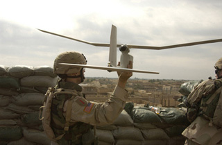 A photograph of an U.S. Army soldier launching a Raven unmanned aerial vehicle. A photograph of an U.S. Army soldier launching a Raven unmanned aerial vehicle.
